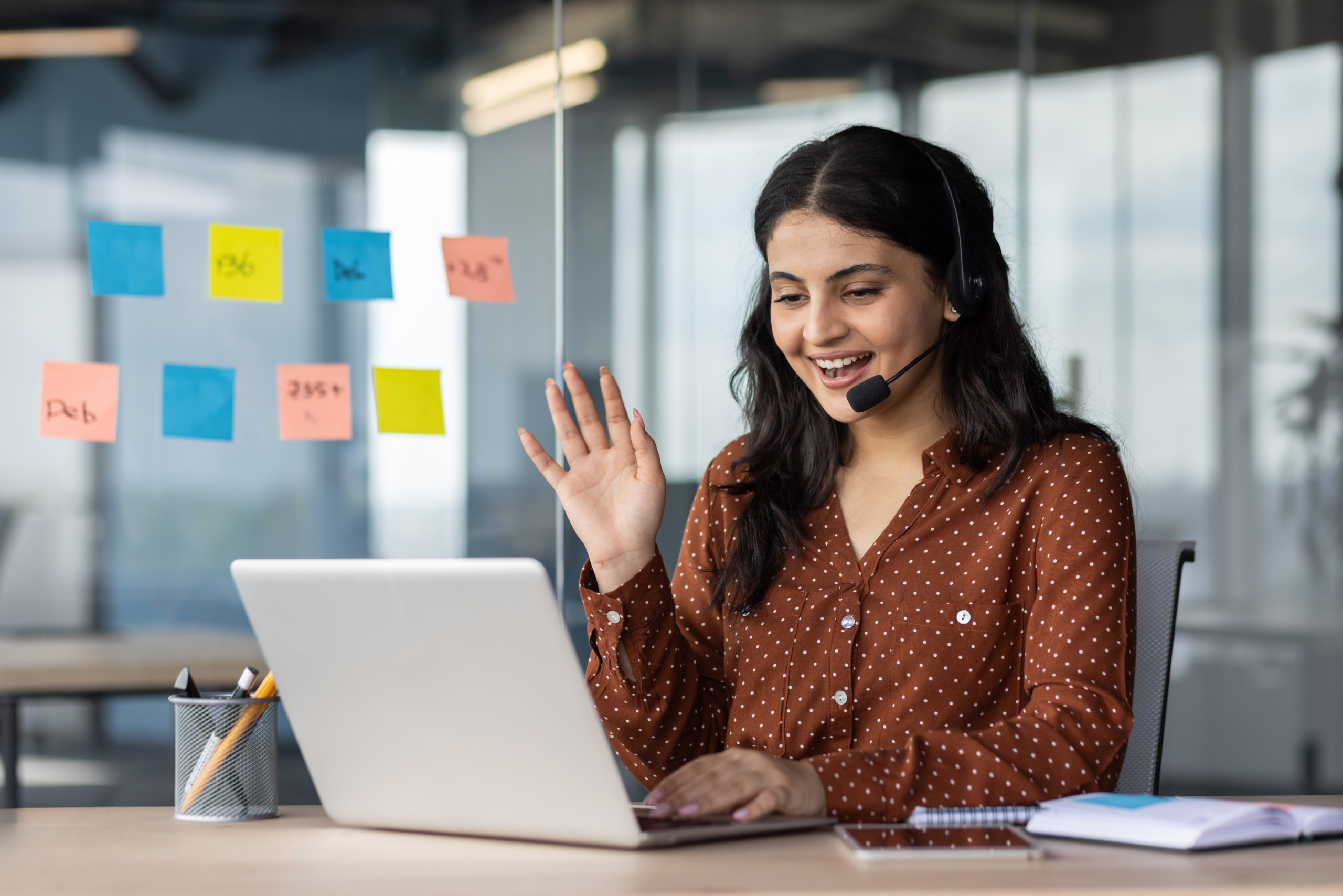 IT Intelligent Assistant - Image of woman waving at laptop screen